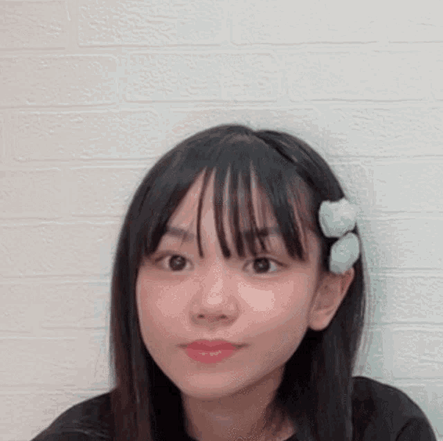 a young girl with a flower in her hair .