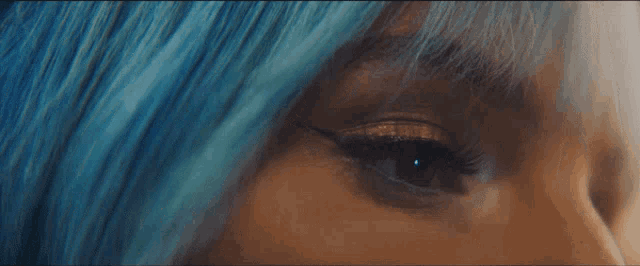 a close up of a woman with blue hair