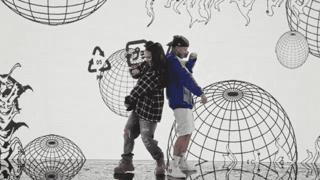 two men are dancing in front of a drawing of a globe and a recycling symbol