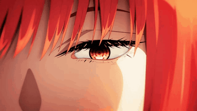 a close up of a person 's eye with a red background