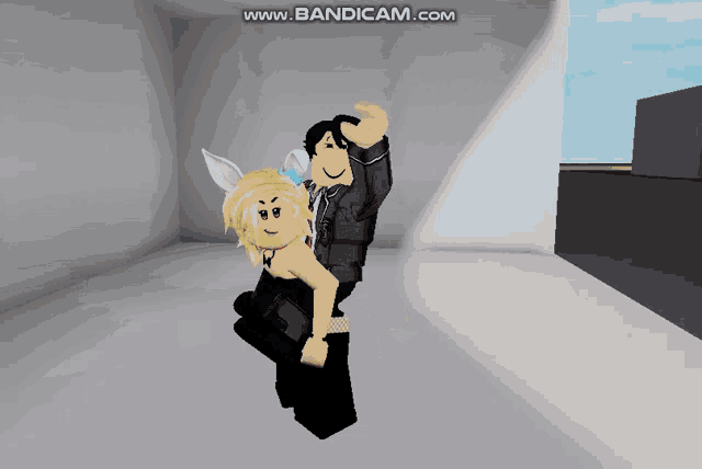 a man is carrying a girl in his arms in a room with the words www.bandicam.com on the bottom right