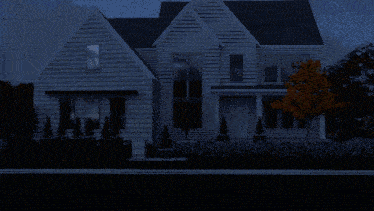 a white house with a black roof and a few windows