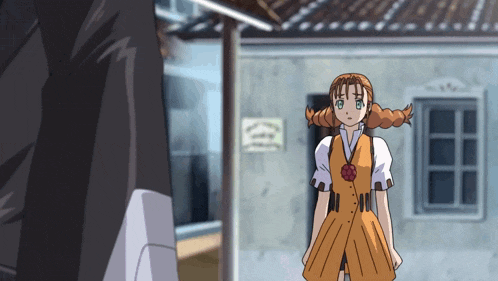 a girl with pigtails stands in front of a building