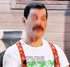a man with a mustache and suspenders is wearing a white shirt and suspenders .