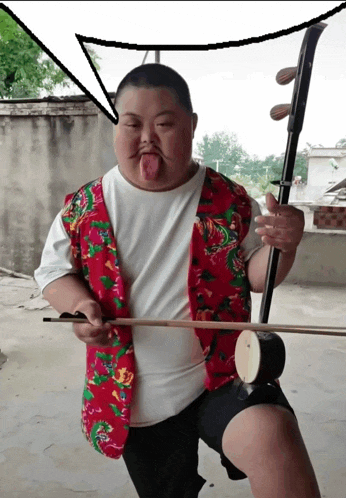 a man in a red vest is holding a violin