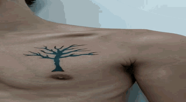 a man with a tree tattoo on his chest
