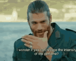a man with a beard is smoking a cigarette and talking about perfume .