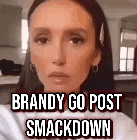 a woman is making a funny face with the words `` brandy go post smackdown '' written on her face .