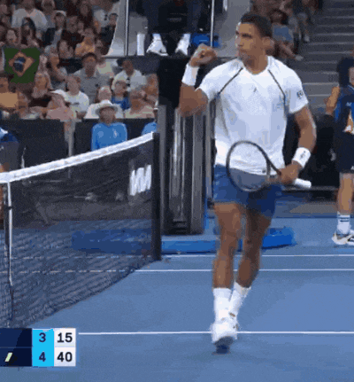 a man holding a tennis racquet on a tennis court with a scoreboard behind him that says 3 15 4 40