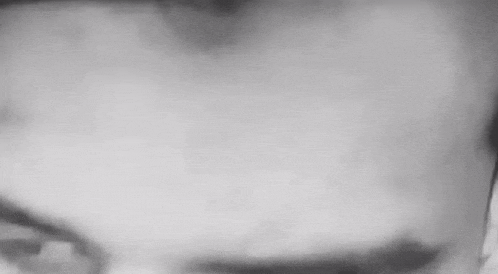 a black and white photo of a person 's eyes looking at the camera .