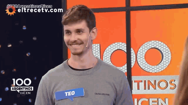 a man wearing a name tag that says teo on it