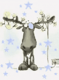 a moose is standing in front of a christmas tree