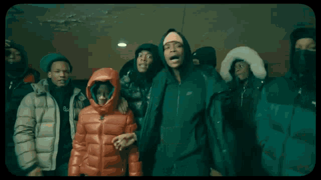 a person wearing a white jacket with a hood is walking in a dark room