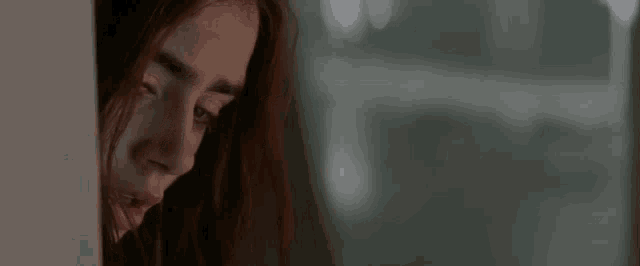 a close up of a woman 's face with blood on her face .