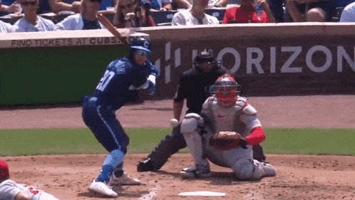 a baseball game is being played in front of a sign that says " find tickets at cubs "