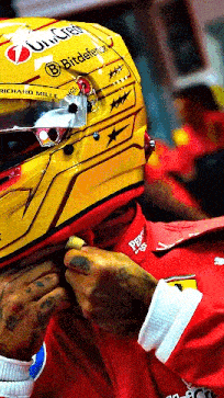 a man wearing a yellow helmet that says richard mille