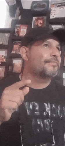 a man with a beard wearing a black shirt that says venom