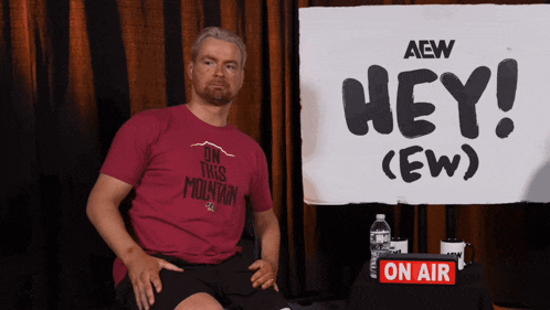 a man wearing a red shirt that says on this mountain
