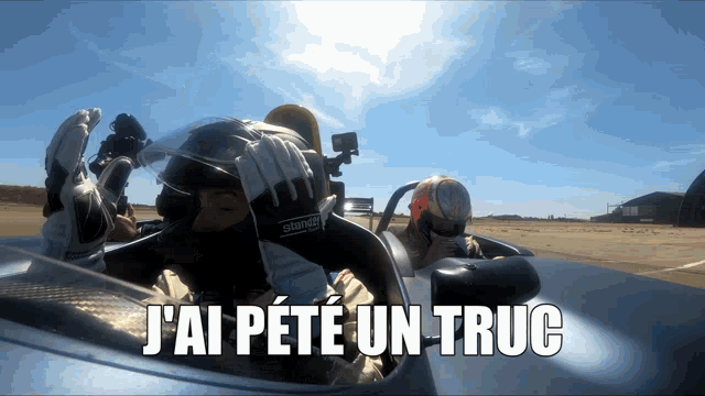 a man in a race car with the words j'ai peté un truc above him