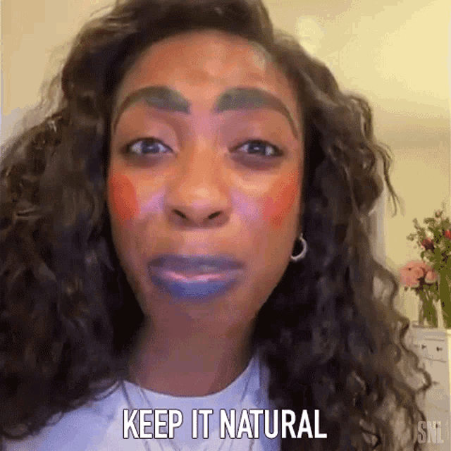a woman with makeup on her face is making a funny face and saying `` keep it natural '' .