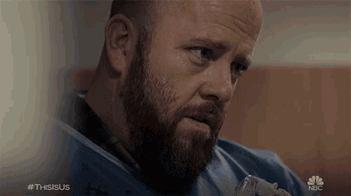 a man with a beard and a nbc logo on the bottom right