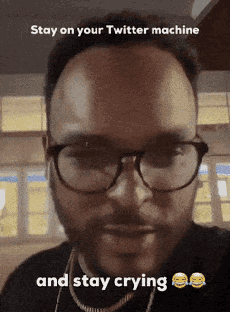 a man wearing glasses says " stay on your twitter machine "