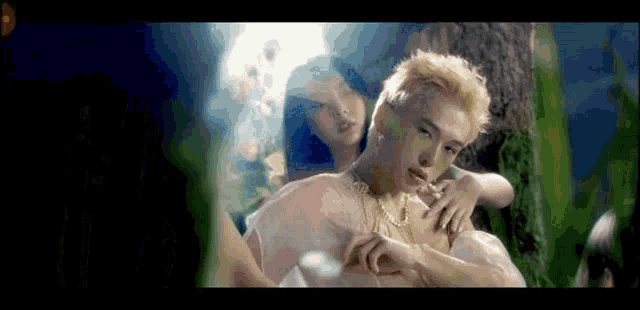 a man in a white dress is holding a woman in a white dress .