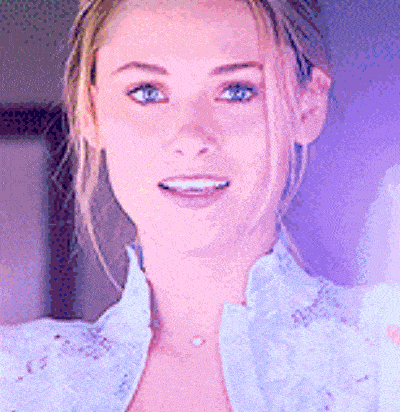 a close up of a woman wearing a white shirt and a necklace