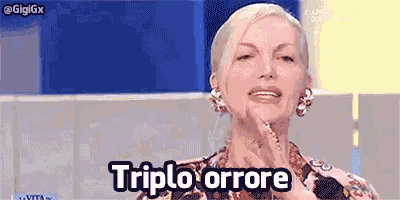 a woman is making a funny face and the words triple errore are on her face .