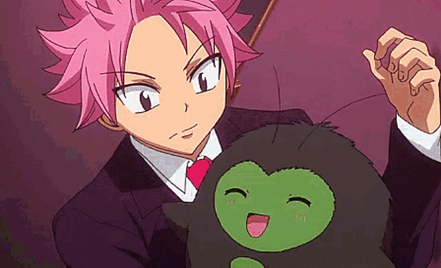 a man with pink hair is holding a black stuffed animal
