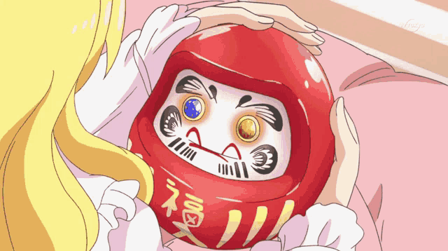 a girl is holding a red ball with chinese characters on it