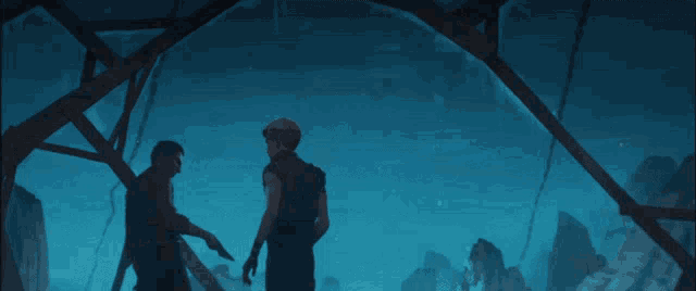 two men are looking at each other in a dark blue background