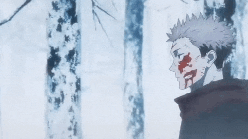 a man with blood on his face is standing in the middle of a forest .