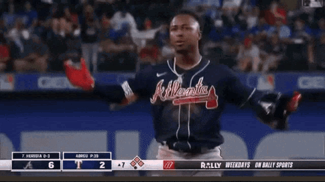 a man wearing a atlanta braves jersey stands on a baseball field