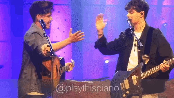 two men playing guitars on a stage with the words @playthispiano