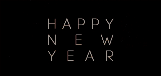 a fireworks display with the words happy new year written in white