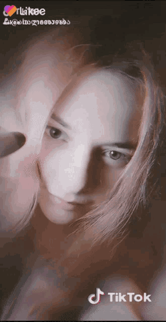 a close up of a woman 's face with a tiktok watermark