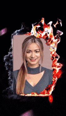 a woman 's face is surrounded by fire and smoke