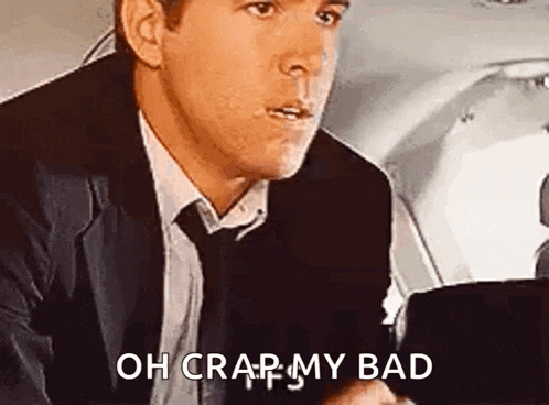 a man in a suit and tie is sitting in a car and saying oh crap my bad .