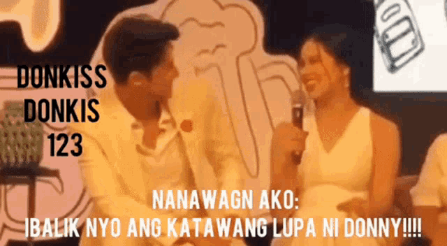 a man and woman are kissing in front of a sign that says donkiss