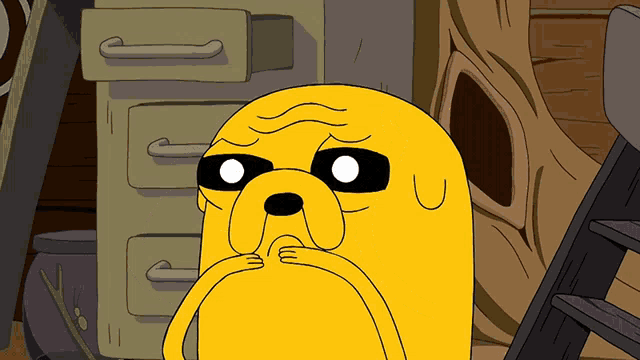 a cartoon character with a sad look on his face is standing in front of a filing cabinet