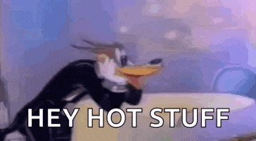 a cartoon penguin is wearing a tuxedo and saying `` hey hot stuff '' while sitting on a bed .