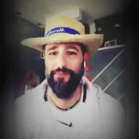 a man with a beard wearing a straw hat with a blue band that says ' montreal ' on it