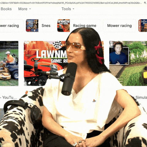 a woman is sitting in front of a microphone with lawnmower game on the screen