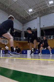 a group of people are playing a game of basketball in a gym sponsored by lms