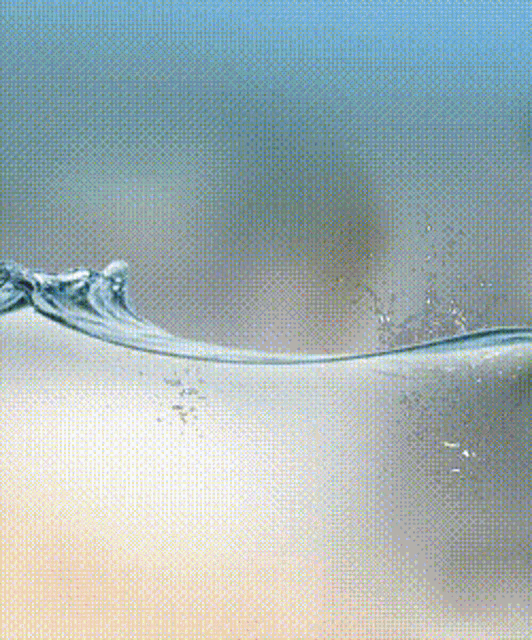 a close up of a wave of water with a blue background