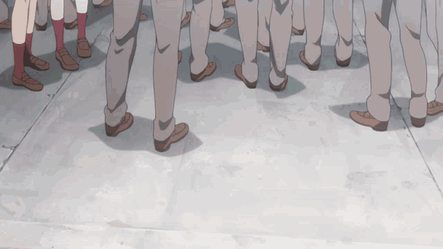 a group of people standing on a sidewalk with their legs showing