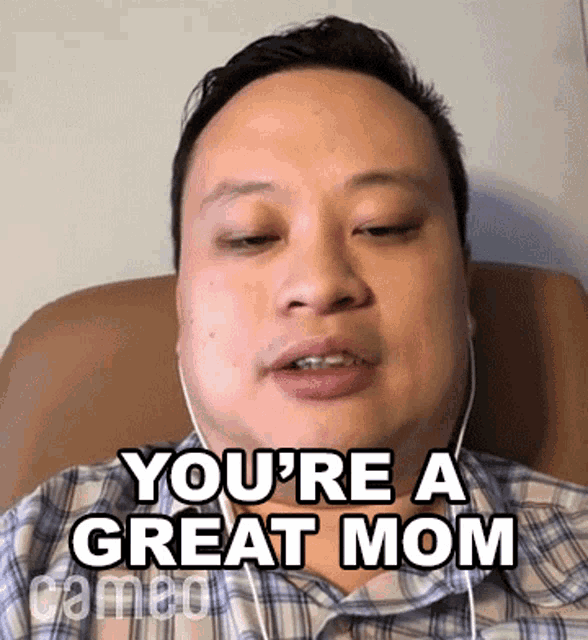 a man is wearing headphones and says you 're a great mom
