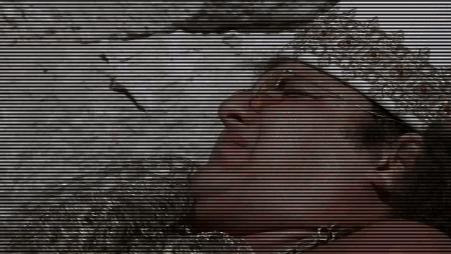 a man wearing a crown and sunglasses is laying on a rock