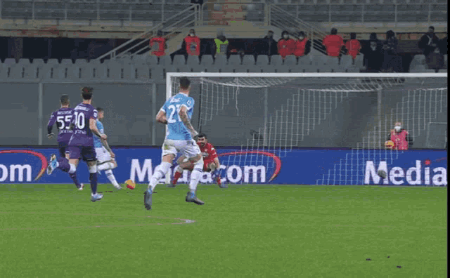 a soccer player with the number 23 on his jersey runs towards the goal
